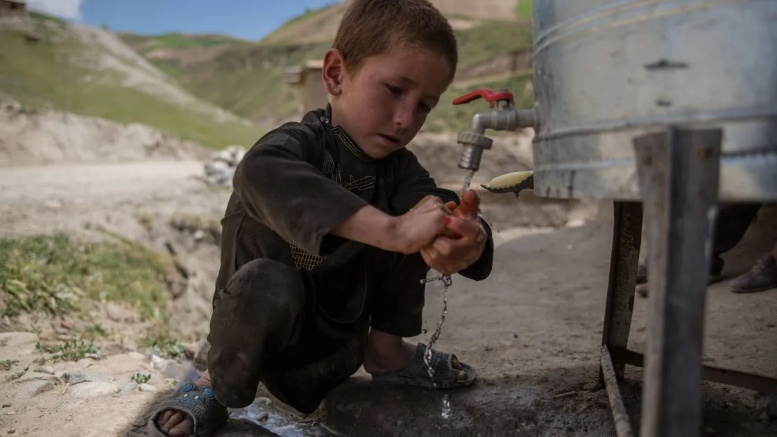 A little boy washes his hands at one of Concern's water stations in Afghanistan. (Photo: Stefanie Glinski / Concern Worldwide)