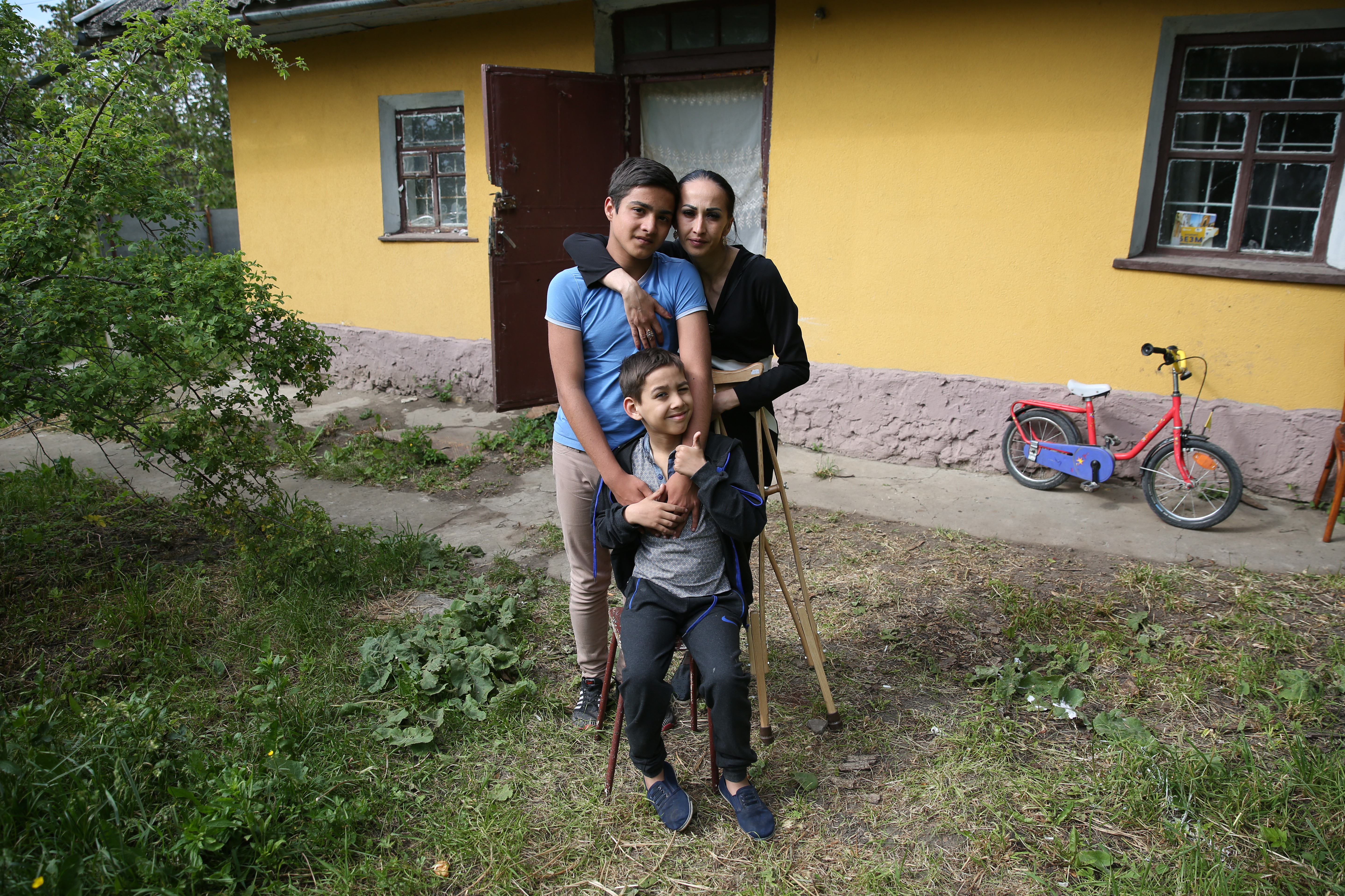 Daryna* and two of her sons, Misha (14, standing) and Sasha (9) at their temporary home in Western Ukraine. Photo: Kieran McConville/Concern Worldwide
