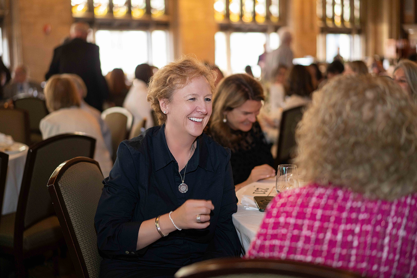 A woman talking and laughing at a table