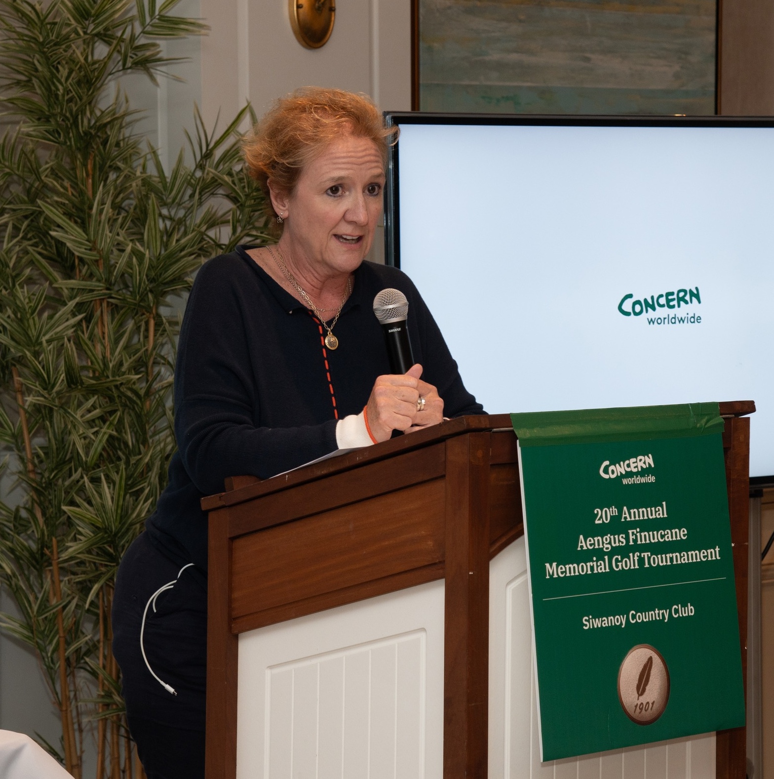 A woman speaks at a podium