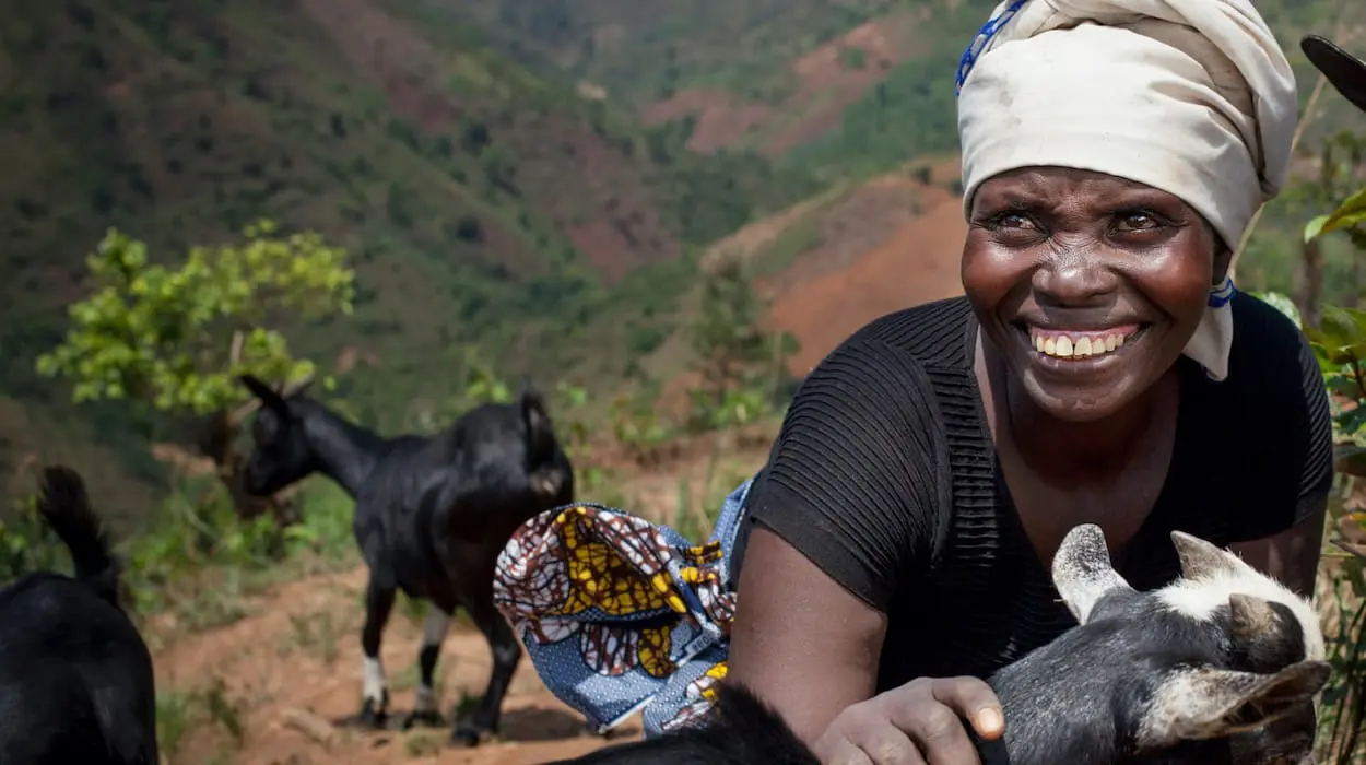 Female farmer in Burundi with goats