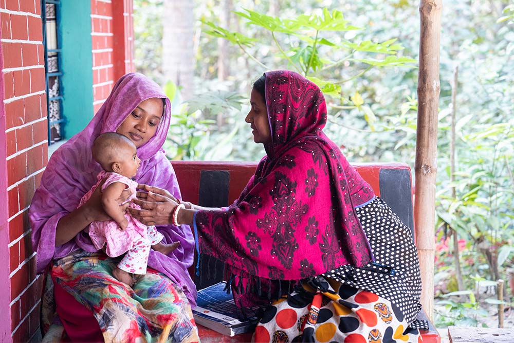 A midwife with mother and baby in Bangladesh