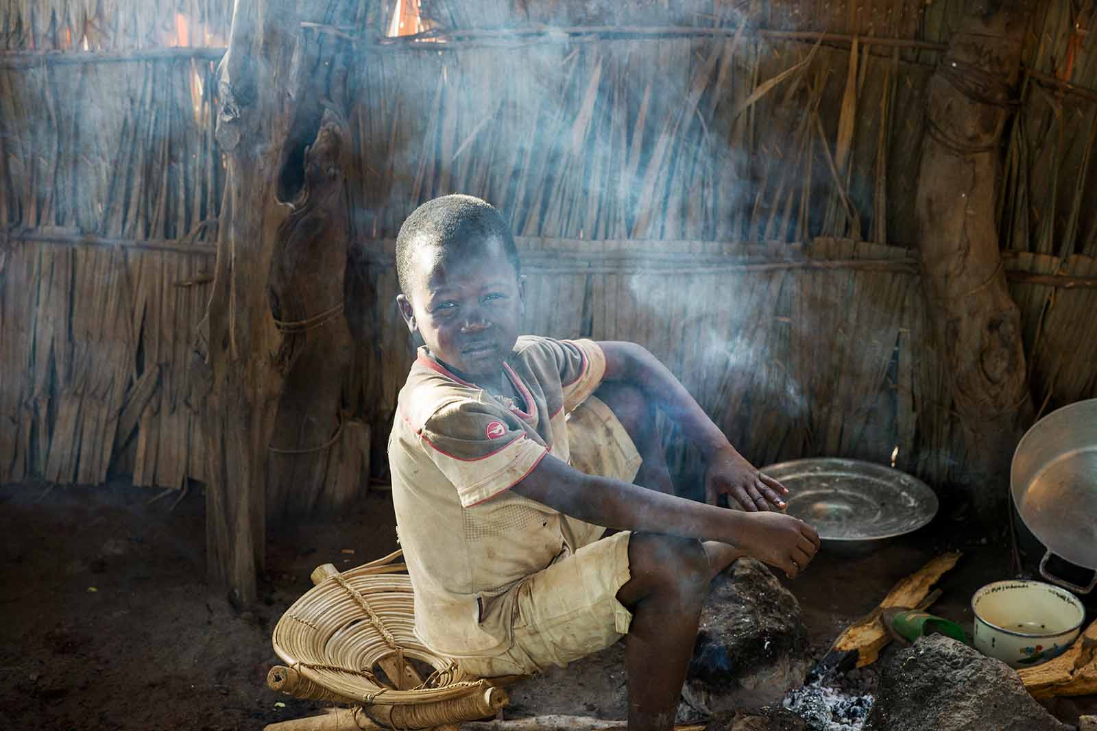 A child in a smoke filled hut