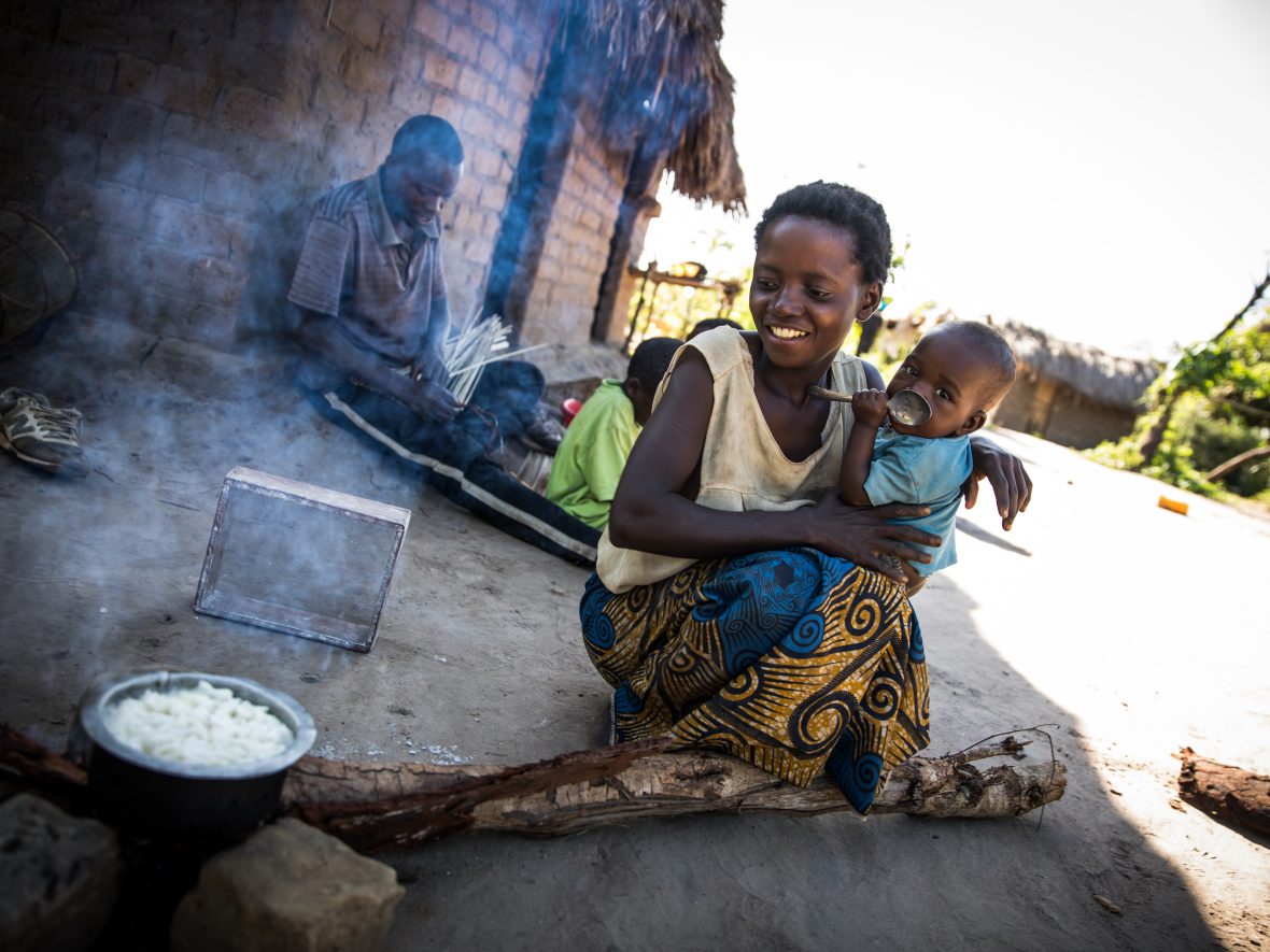 Mado Kabulo, 29, prepares breakfast to share with her husband Eric and their children in the village of Pension, Manono Territory. They were displaced during fighting in 2016 and have struggled ever since, most recently being affected by the loss of many of their crops. They've recently joined the Graduation program run by Concern in the DRC, which provides targeted business trainings, cash transfers, and access to savings and loans programs to create opportunities for those living in poverty. (Photo: Hugh Kinsella Cunningham)