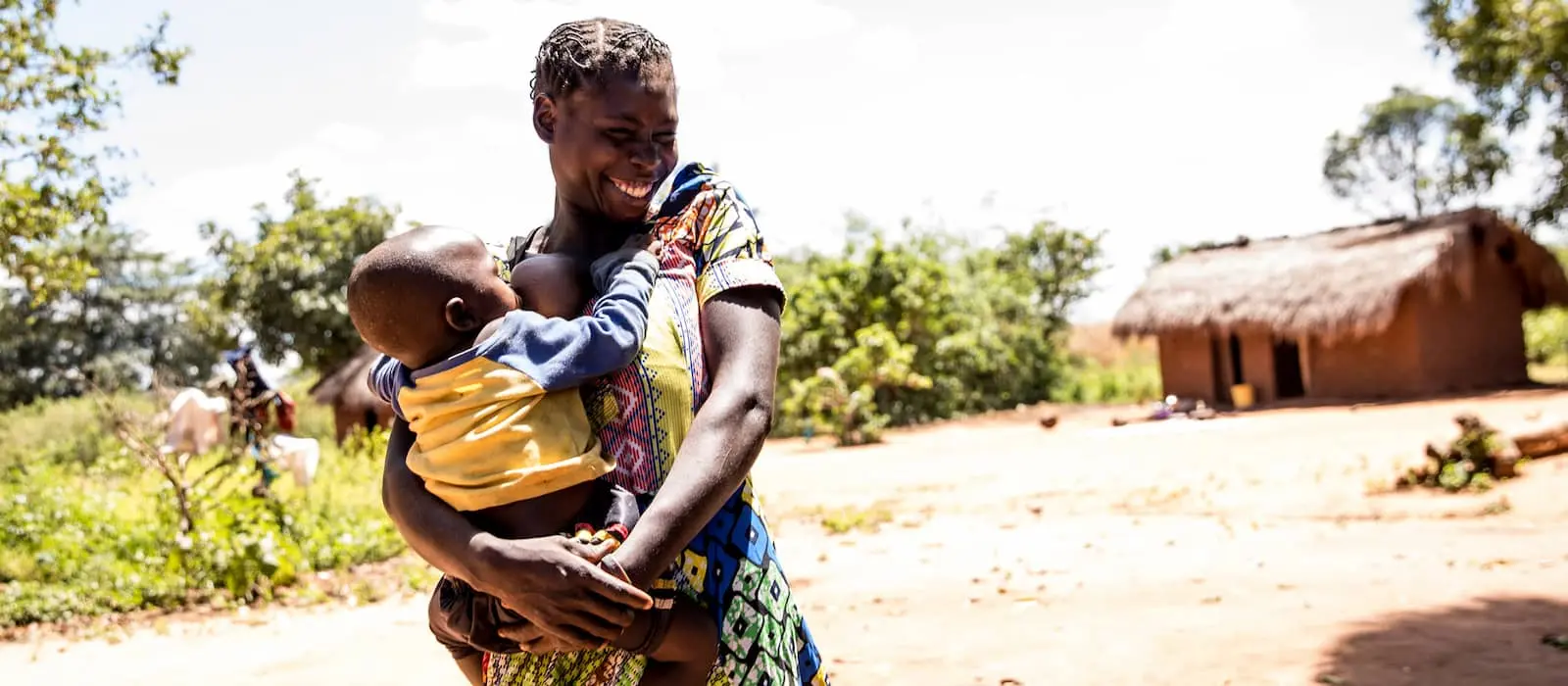 Natalie Ngoyi, 20, is seen at home with her 1 year old baby, Adere, in the town of Pension, Manono Territory.