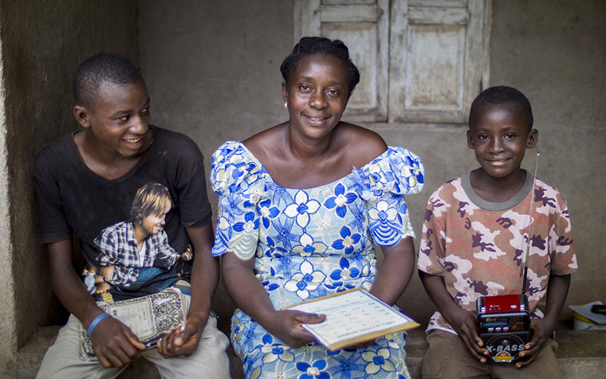 Hawa “Baby” Conteh, with her sons Mada Karimu (15) and Ishmel Jawera (7), both whom took part in “School By Radio” during the Ebola outbreak. (Photo: Kieran McConville/Concern Worldwide)