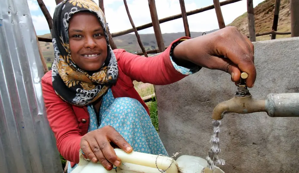 Dereba Kebele collects water from a water source built in Ethiopia