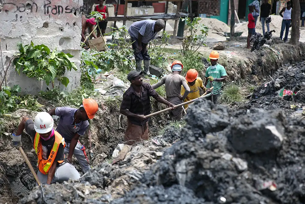 Men clearing a drainage canal in Haiti.