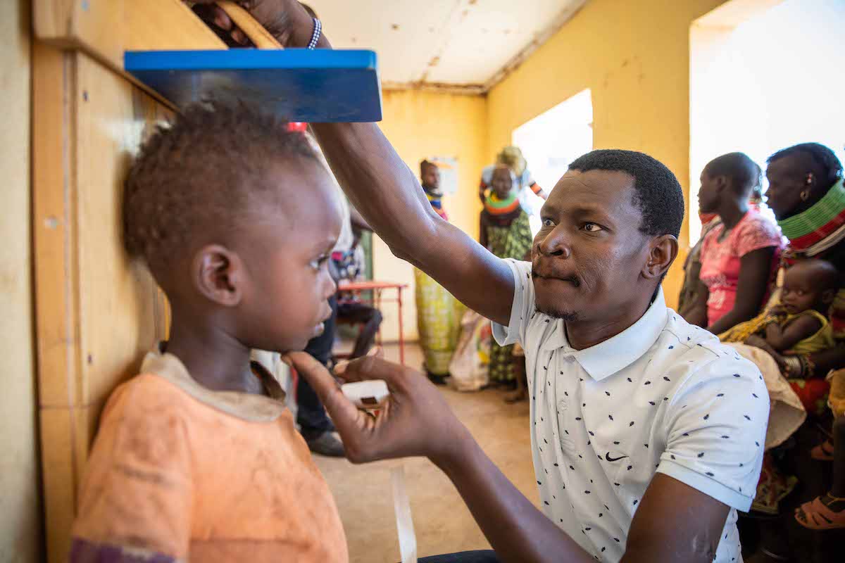 Jacob Eurien measures the height of patient Simon Esibitar to screen for stunting at a malnutrition clinic in Lekwasimyen in Northern Kenya's Turkana province. (Photo: Lisa Murray/Concern Worldwide)