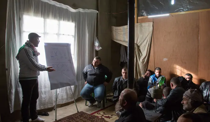 Concern Protection Field Officer Rami Fares gives a session on gender-based violence to Syrian refugee men in Tal Abbas in Akkar, northern Lebanon