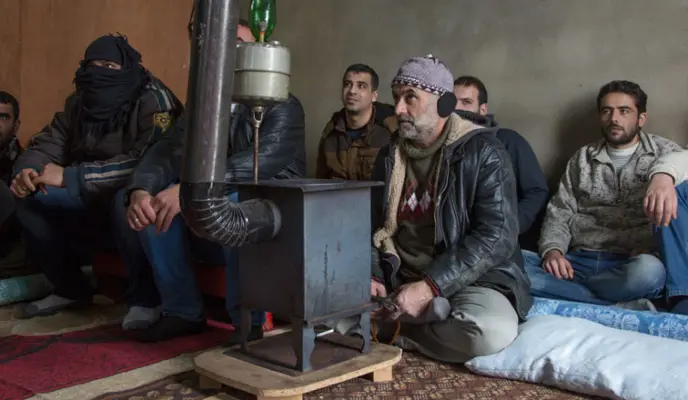 Syrian refugees take part in a meeting to discuss their issues of helplessness and how to cope.