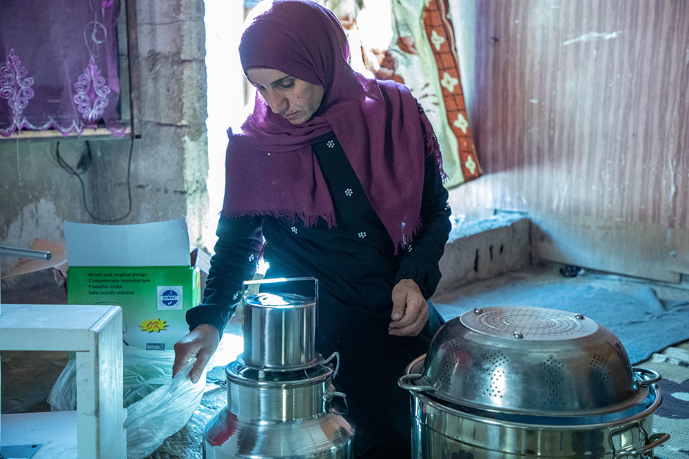 A syrian refugee in Lebanon with cheesemaking equipment