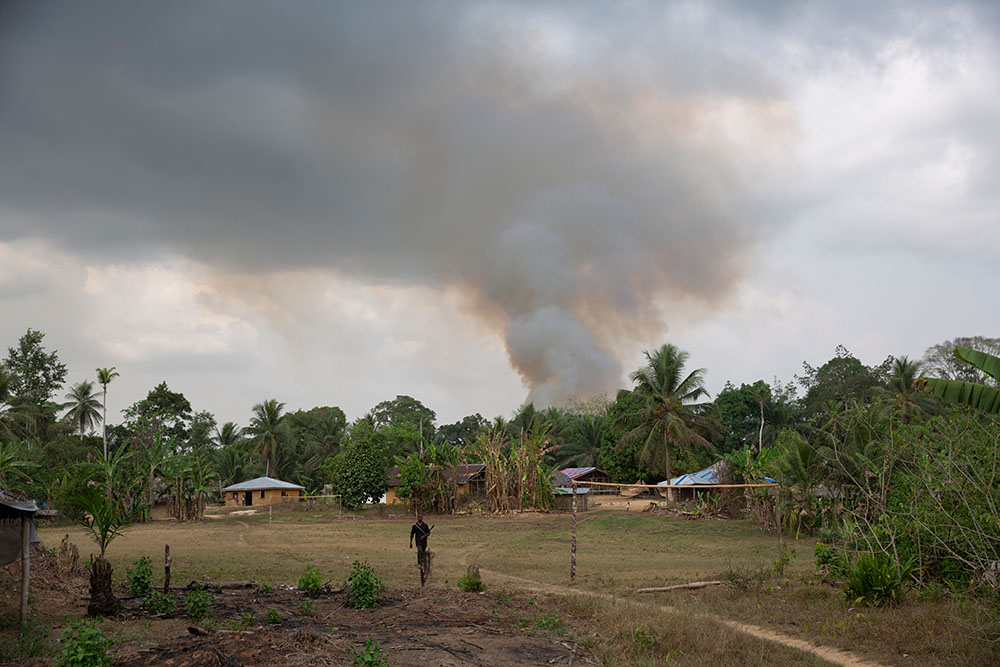 Smoke rising above a village in Liberia