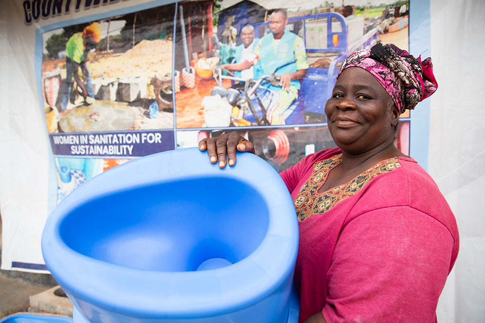 A woman with a SATO toilet pan in Liberia