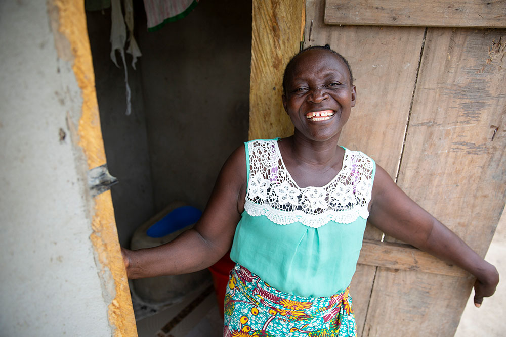 A Liberian woman outside her newly-built latrine