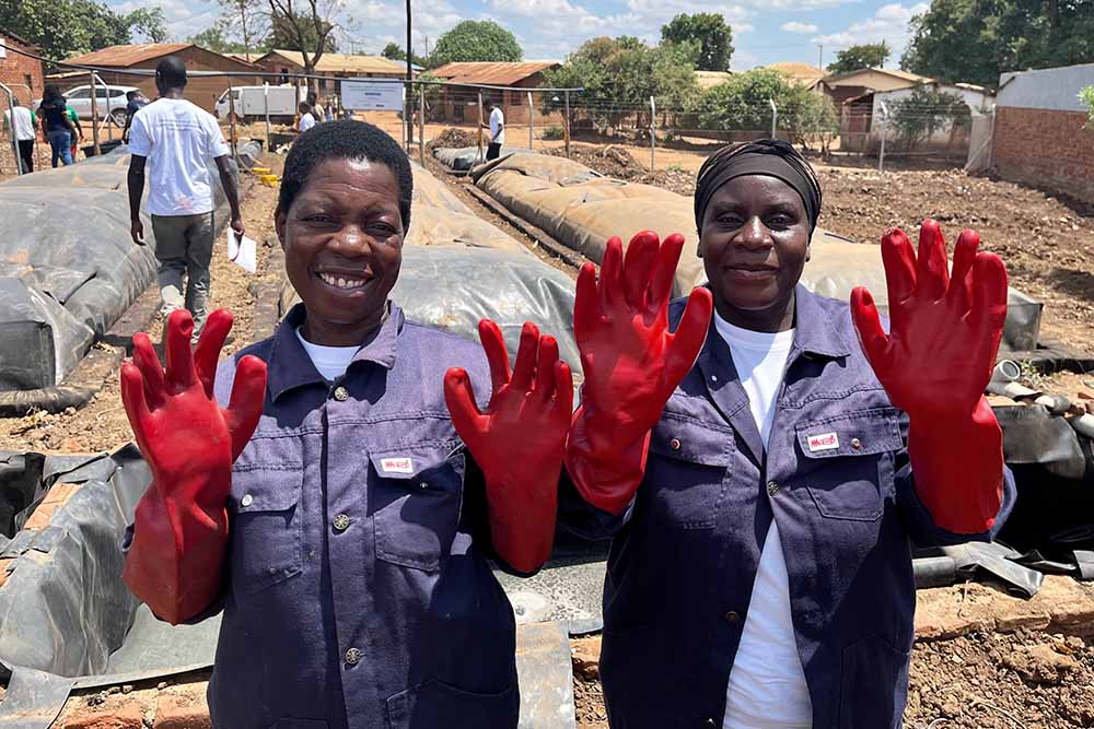 Two women at a biogas facility in Malawi.