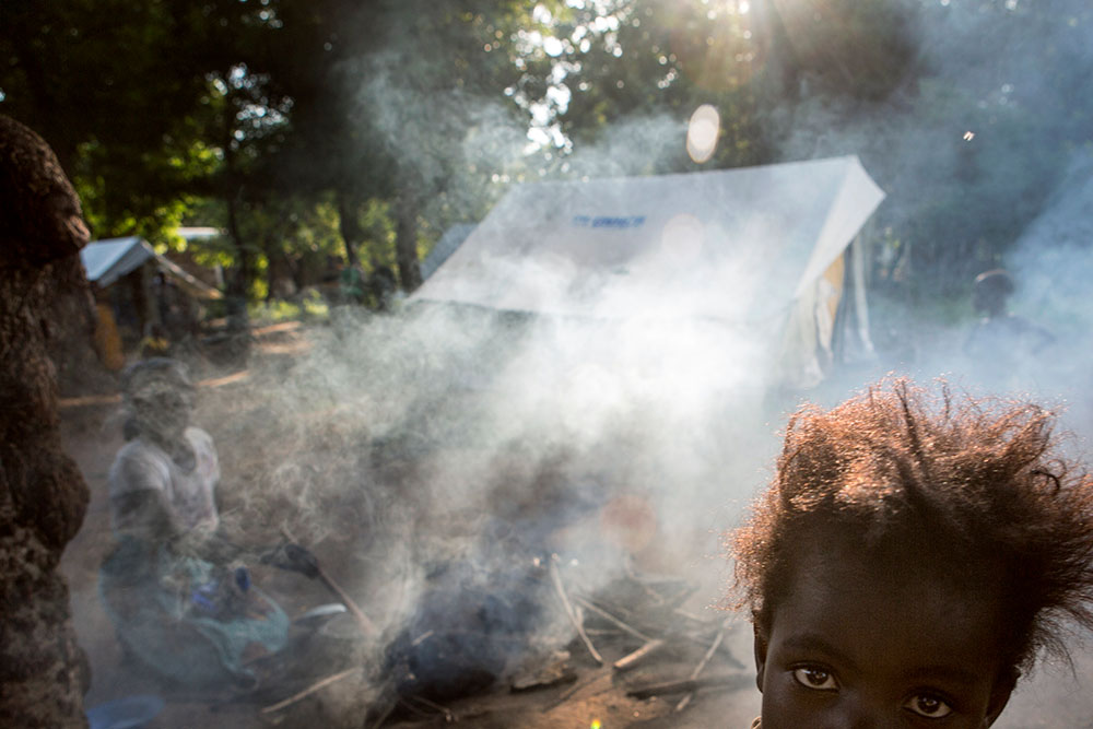 A child in front of a cooking fire in Malawi