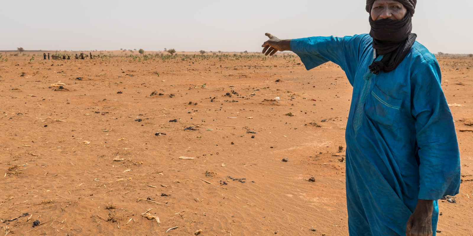 Nigerian man indicating the effects of climate change on Garmazaye Village