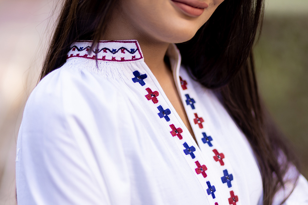 Woman modeling an embroidered blouse