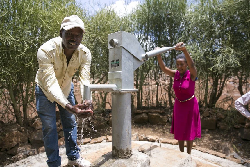 Concern staff test a newly installed communal water pump in an Ethiopian village.