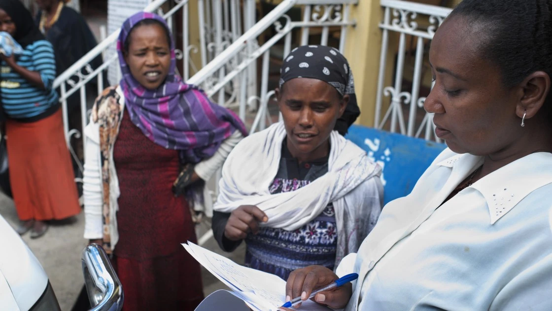 Hibret Tesemma helps distribute free clothing to HIV-positive women in Addis Ababa, at the Mekdim Association, an Ethiopian NGO opened in 1997 and supported by Concern Worldwide from 2001 to 2013. (Photo: Cheney Orr/Concern Worldwide)