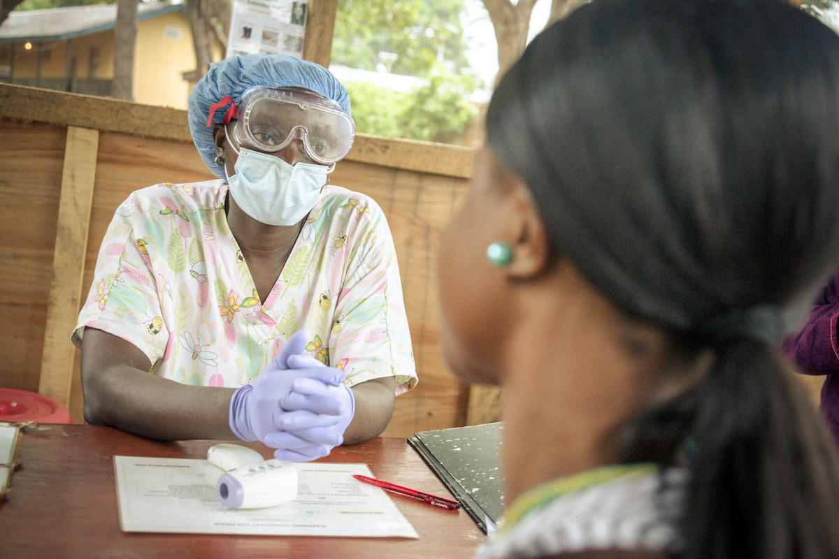Nurse Emma Senesie checks all patients and visitors for signs of Ebola before they enter a clinic in Waterloo during the 2014-16 Ebola outbreak in Sierra Leone. (Photo: Michael Duff / Concern Worldwide)