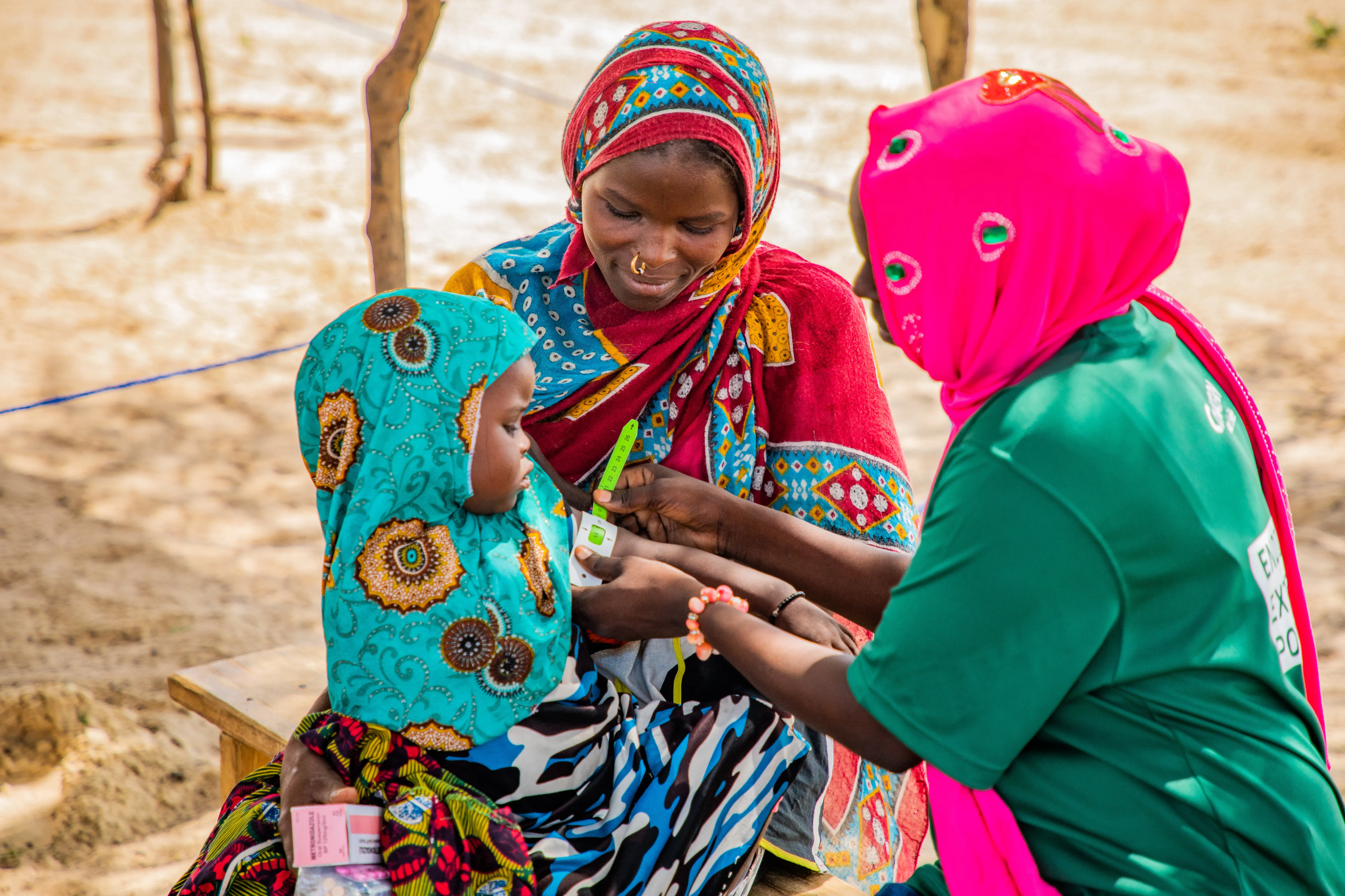 A Concern worker checks a young child for malnutrition in Chad