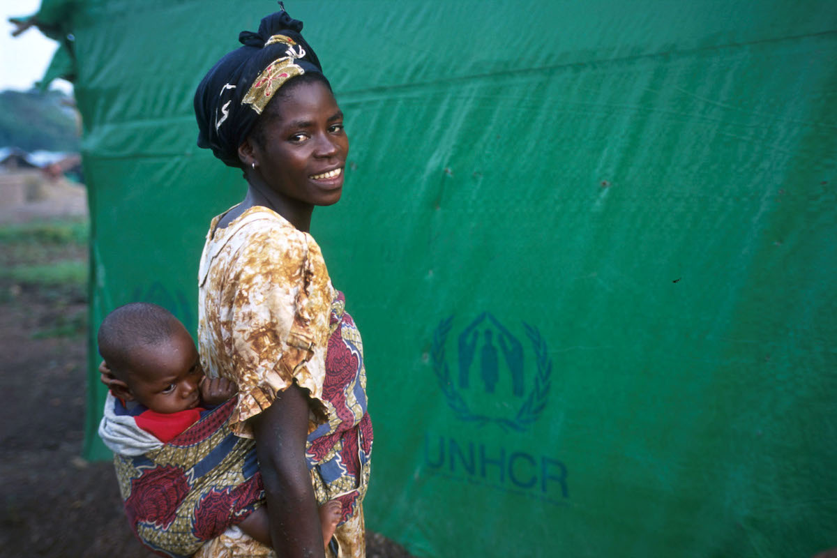 A Liberian refugee woman and her child seek asylum in Sierra Leone during Liberia's civil war, 2002.