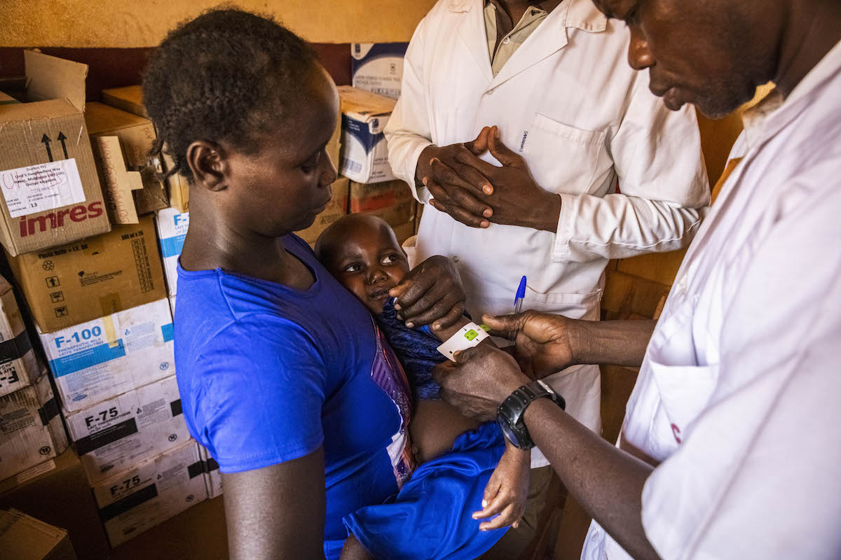 Tatiana* and baby Arka* is checked by health assistant Alain Prospoer Ouafio (left) and Dr Thiery Kouda at Yaloké Secondary Hospital. (Photo: Ed Ram/Concern Worldwide)
