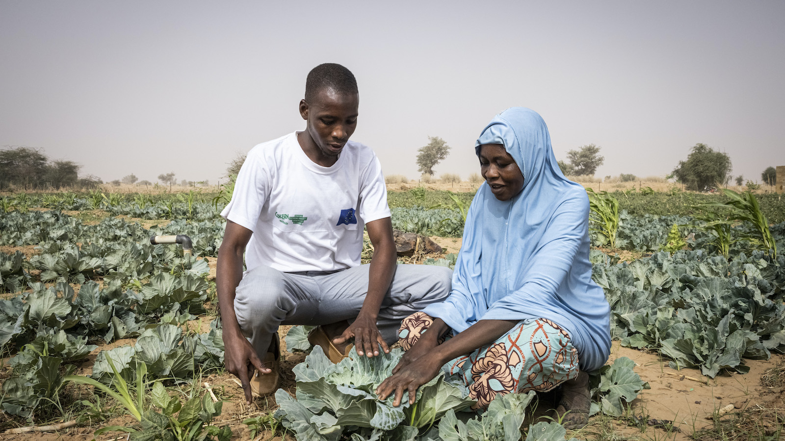 Concern worker Hashimou Abdouram with Haoua Saadou (31) in the community home garden. (Photo: Ed Ram/Concern Worldwide)