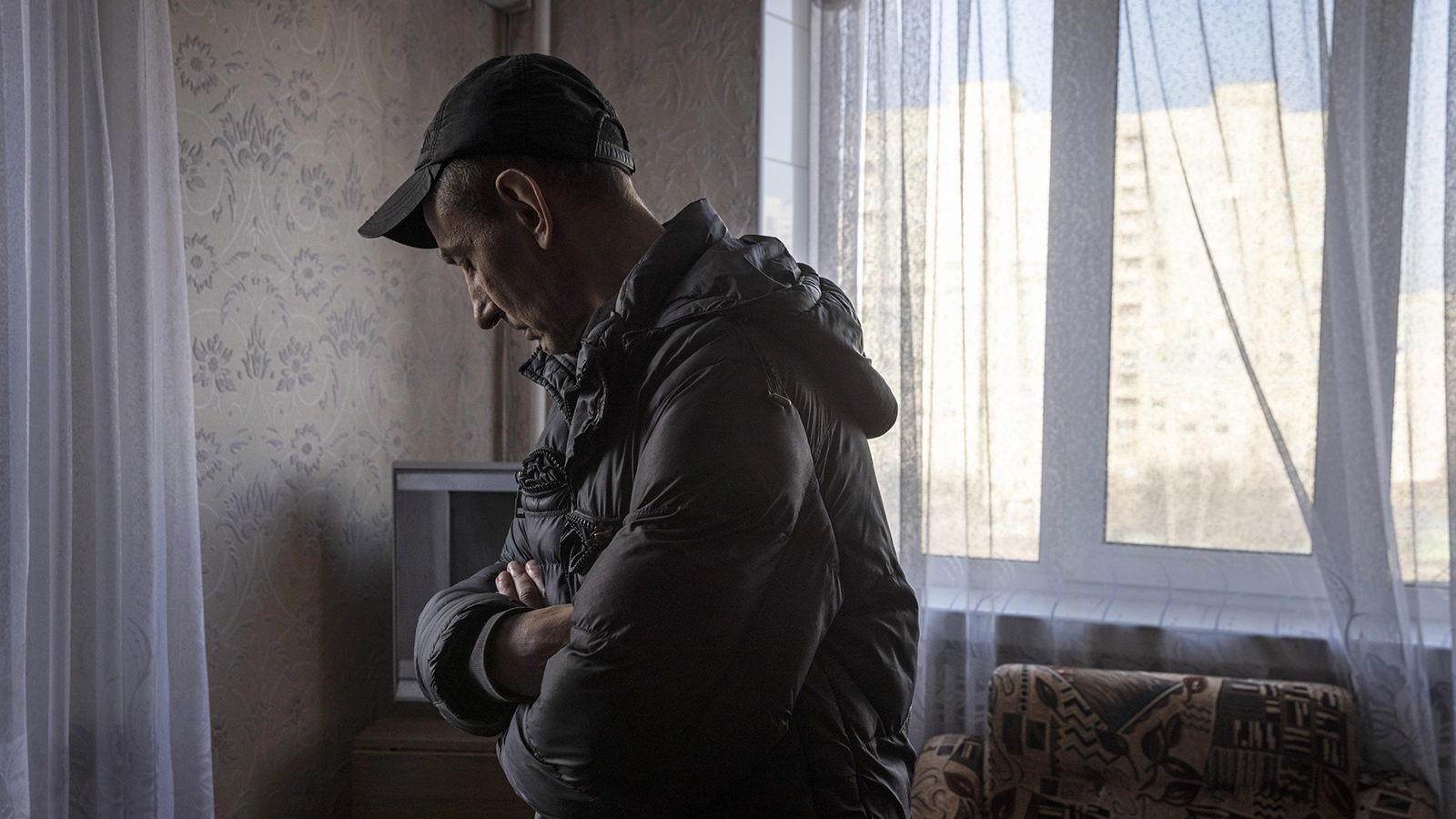 A man looks at the damage in his flat in north eastern Kharkiv due to conflict in the region. (Photo: Ed Ram/Concern Worldwide)