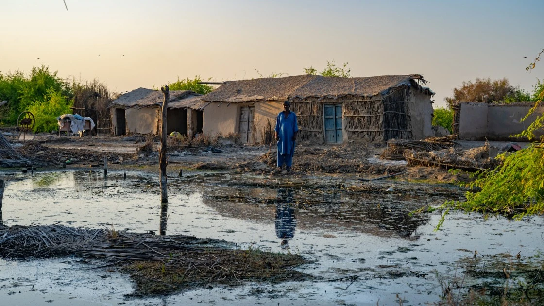 Dalio standing among the devastation left behind by the floods in Mirpur Khas district of Sindh. Photo: Ingenious Captures/Concern Worldwide