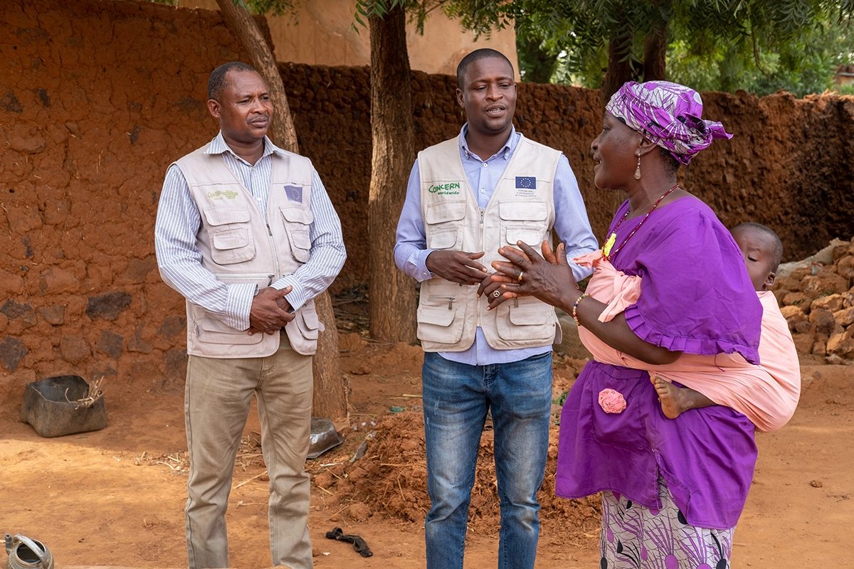 Community health volunteer and grandmother Mariama Badje speaks with Concern's Technical Surge Specialist Issifou Gouzaye and Nutritional Health Advisor Mohamed Djibrillou. (Photo: Darren Vaughan/Concern Worldwide)