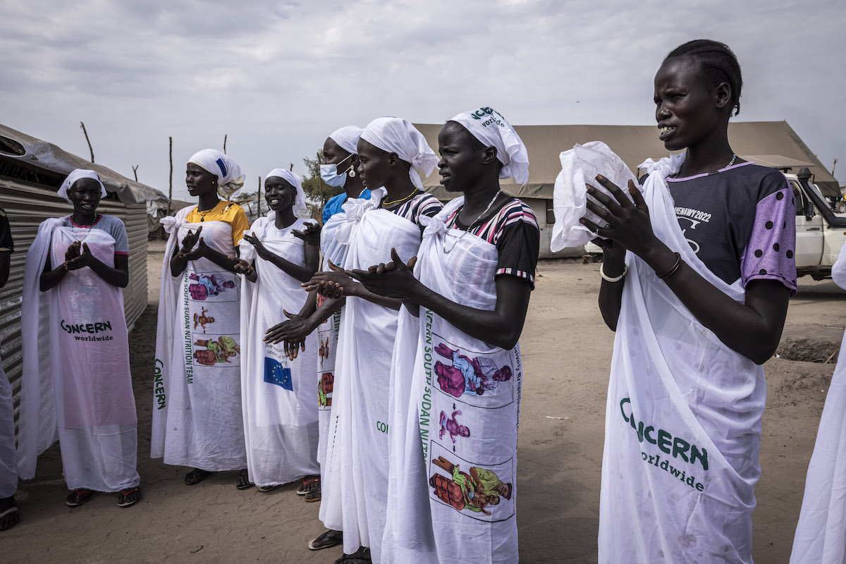 Women sing to welcome guests at a Health centre in a IDP site in Bentiu, Unity State. (Photo: Ed Ram/Concern Worldwide)