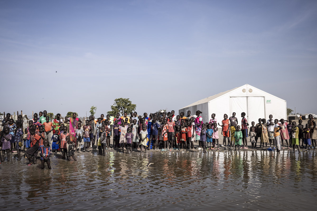 People wait for cash distribution in Chotyiel, a settlement surrounded by flood water near Gwit, south of Bentiu in Unity State. (Photo: Ed Ram/Concern Worldwide)