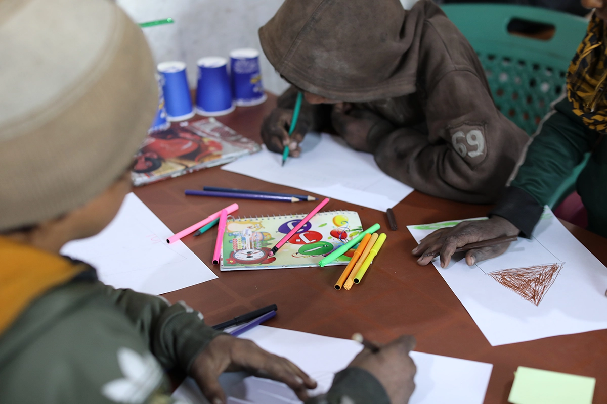 A drawing class at a non-formal education center (NFE) for displaced children in Syria. NFEs are designed to help give children a sense of well-being and normalcy after experiencing trauma so that they can re-enter a formal education system when they're ready. (Photo: Jennifer Nolan/Concern Worldwide)