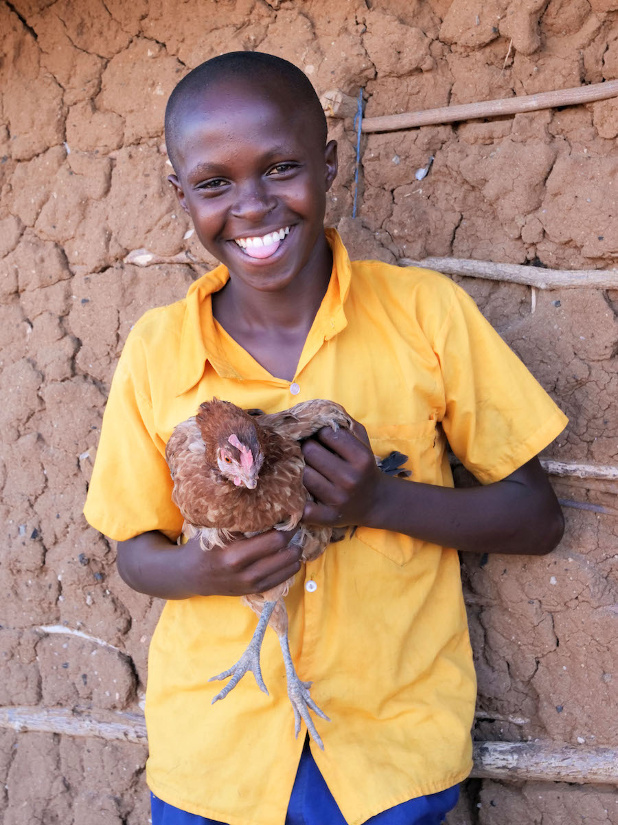 Leonard Kibbe holding a chicken in Matagala, Tana River. (Photo: Eugene Ikua/Concern Worldwide)