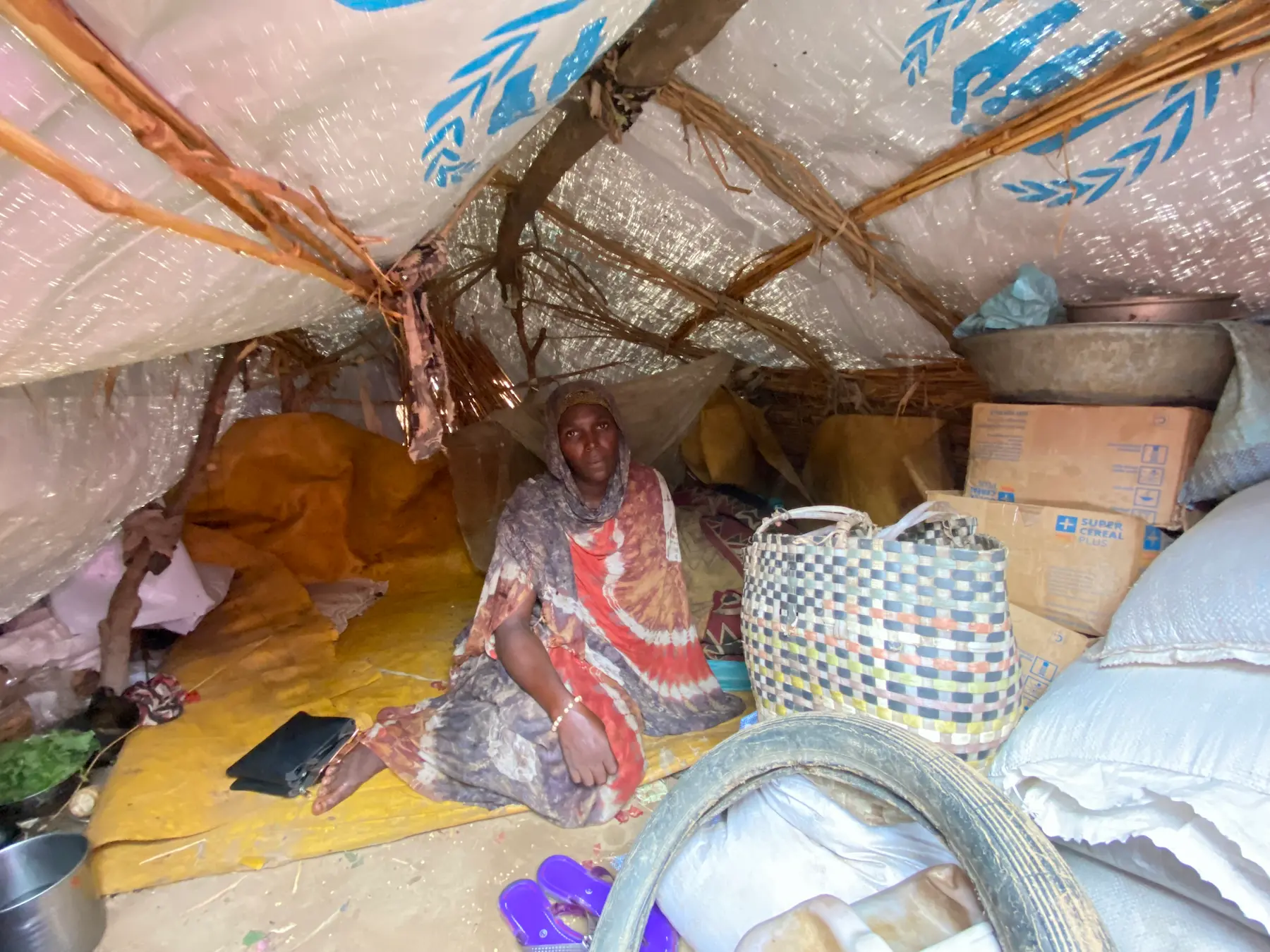 A displaced Sudanese woman in a temporary shelter