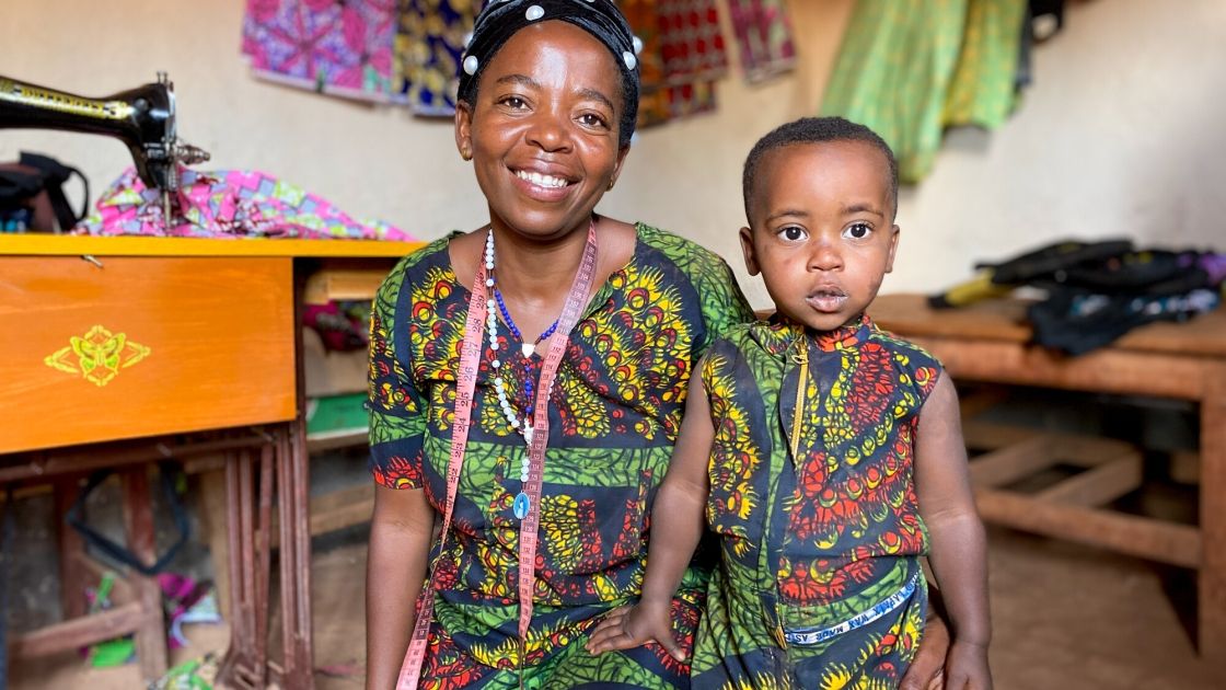 Alexia Mukashyaka (40) and her daughter Brigit (2) at her tailoring shop in Mugombwa, Gisagara. (Photo: Eugene Ikua / Concern Worldwide)