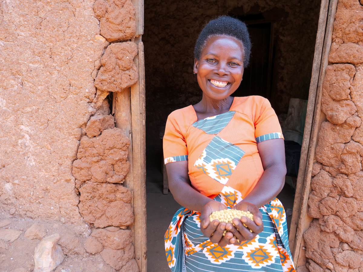 Marie-Claire with a handful of soy beans that she has harvested from her land and will sell to her neighbours. (Photo: Eugene Ikua/Concern Worldwide)