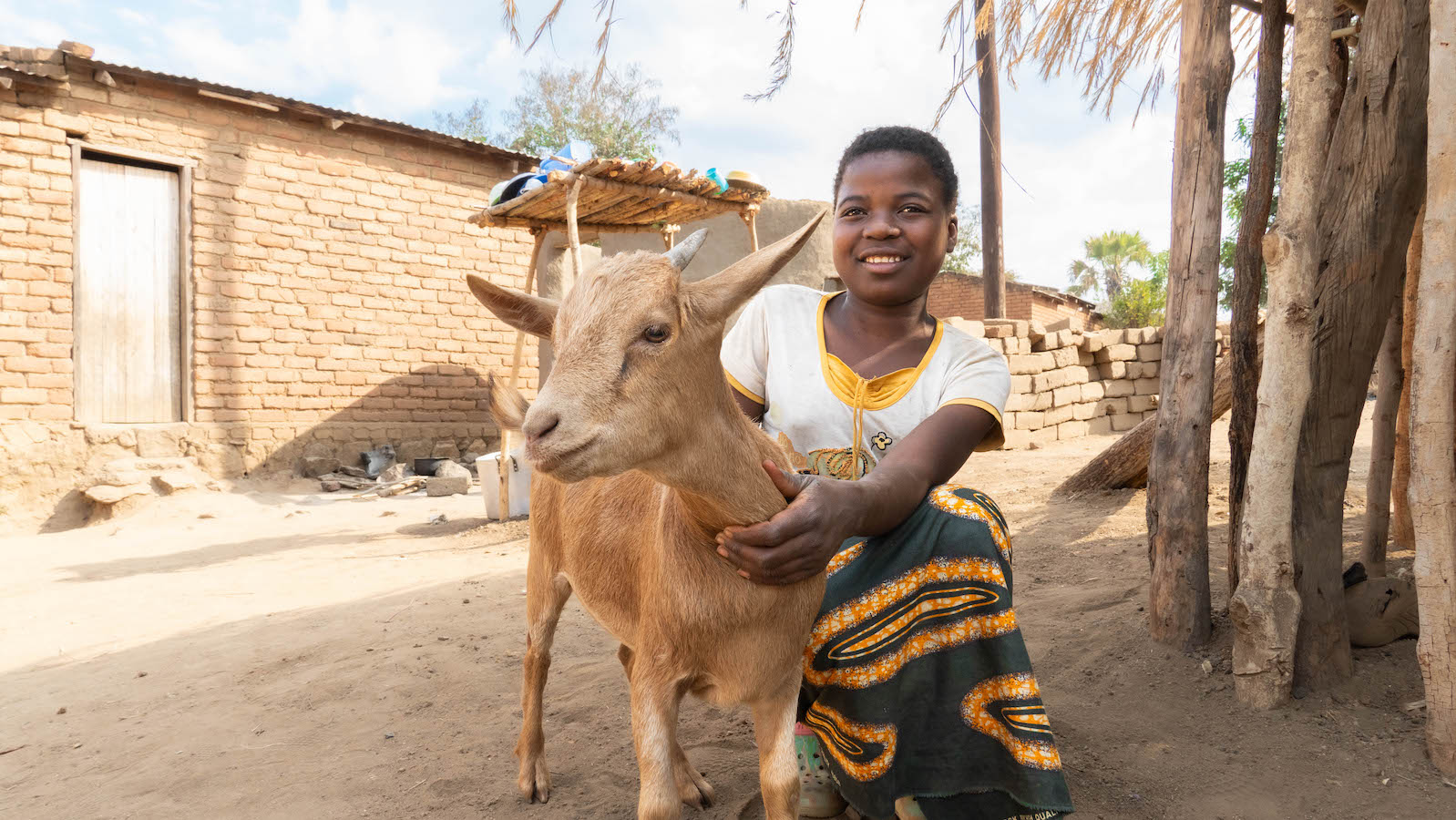 Josephine Kazembe's granddaughter Maria (12) with a goat purchased with money from Concern in Magaleta village in Neno district. (Photo: Chris Gagnon/Concern Worldwide)