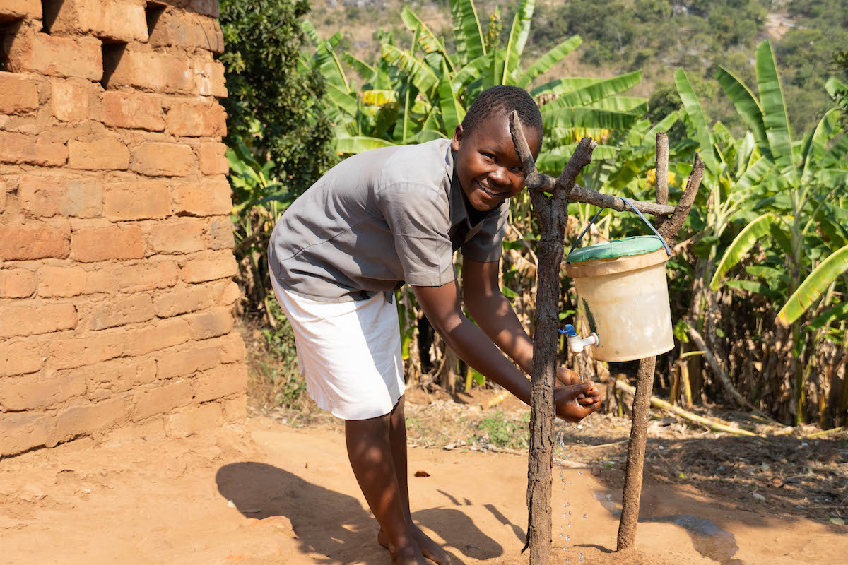 Roda uses a veronica bucket that her family installed as part of a hygiene training led by Concern. (Photo: Chris Gagnon/Concern Worldwide)