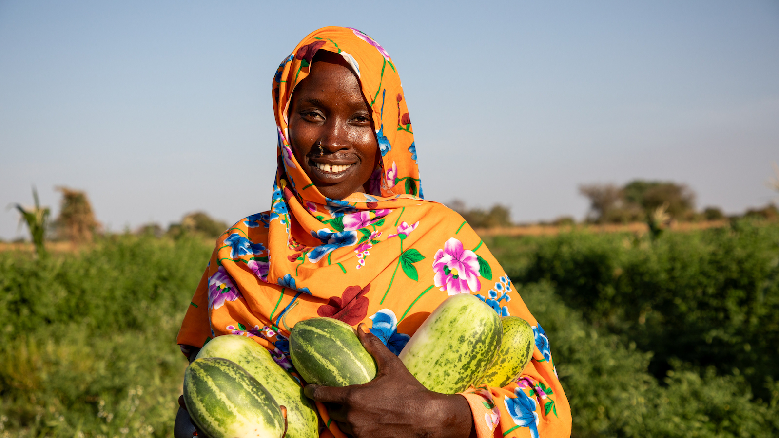 Mahadia Gamar (24) showcases her cucumbers at her farm in Karo village. (Photo: Eugene Ikua/Concern Worldwide)