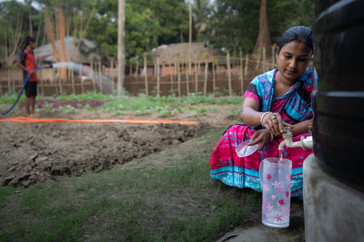 Pinky Ray pours herself safe drinking water to prepare meals for her family. Rainwater harvested throughout the last rainy season could serve her family for almost the rest of the year in Chordanga, Bangladesh. (Photo: Mumit M/Concern Worldwide)