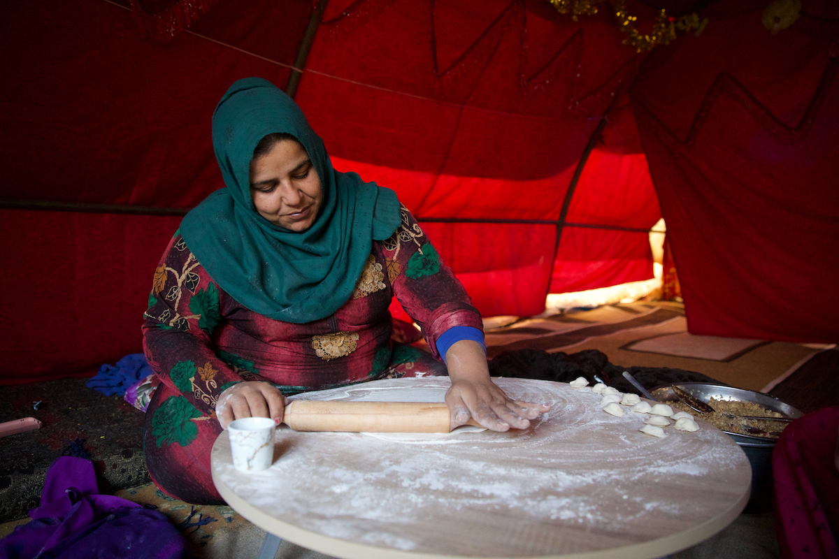 Ramya* (29) prepares food for her family of nine people. She rolls out the dough to prepare the famous Syrian dish shashbark, in which the dough is stuffed with meat and onions, but the poverty that the family suffers from has forced her to use less expensive fillings. (Photo: Ali Haj Suleiman/DEC/Fairpicture)