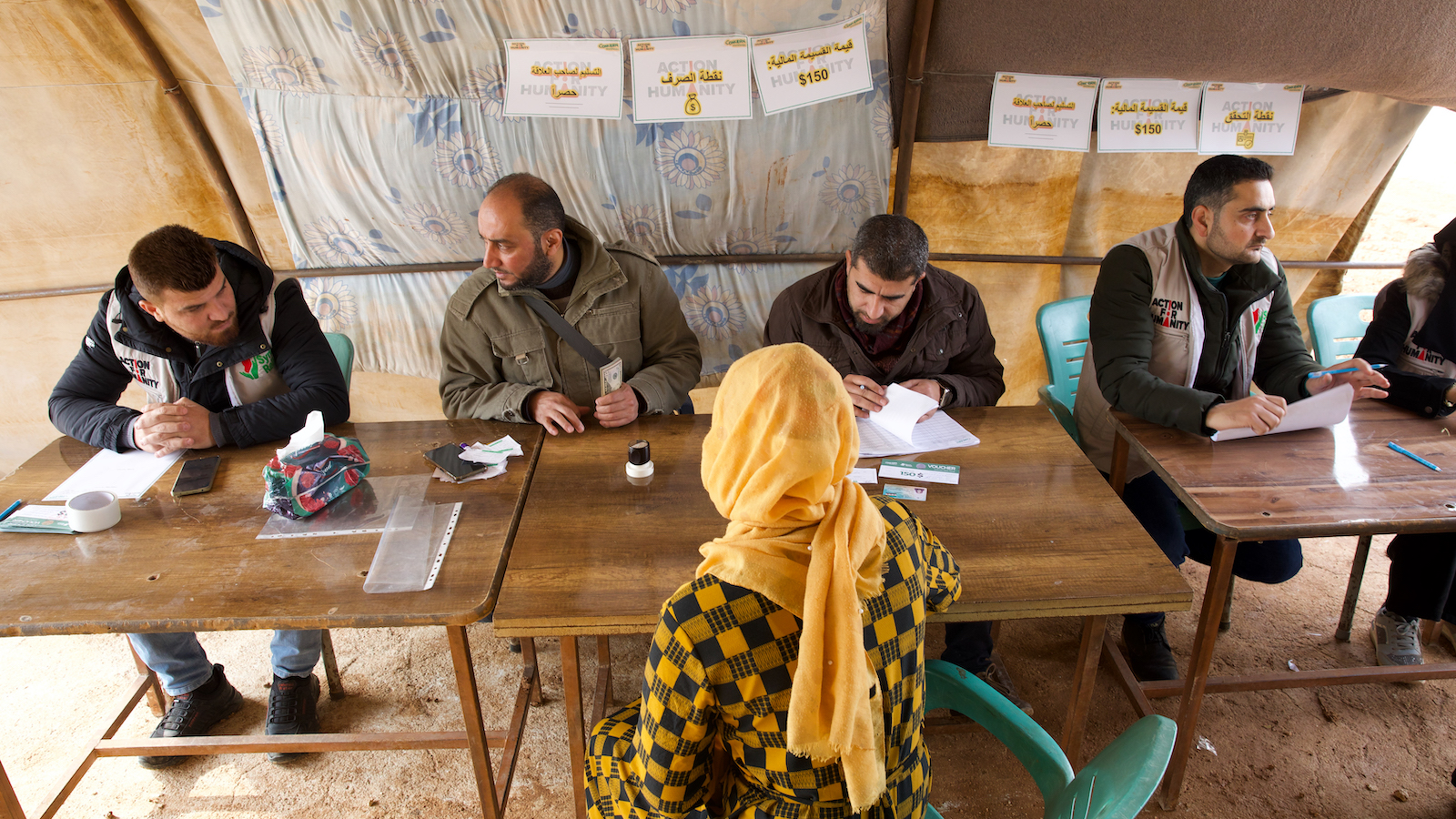 Members of the Syria Relief team deliver the cash vouchers to people affected by the February 2023 earthquake. (Photo: Ali Haj Suleiman/DEC/Fairpicture)