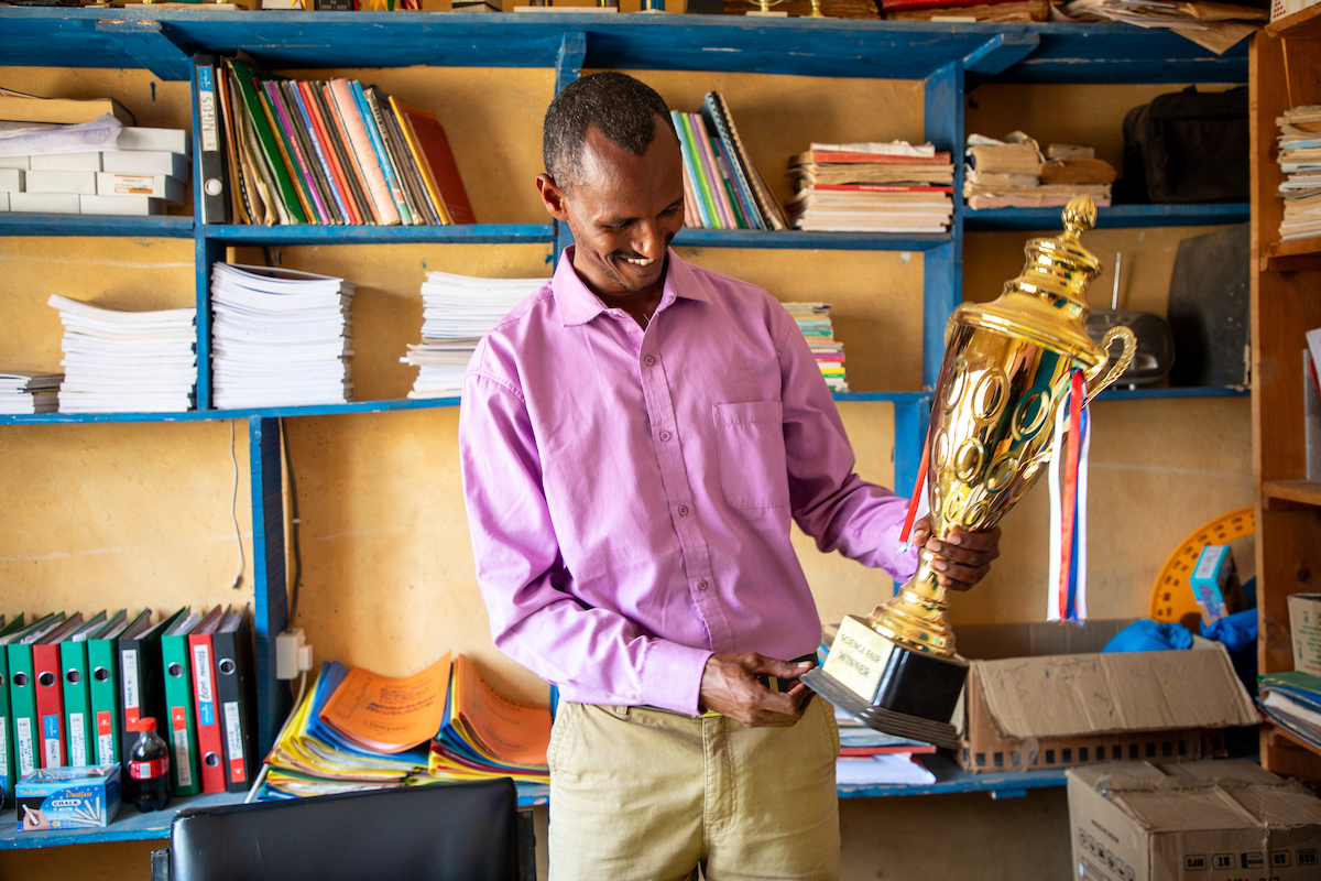 Boru Ali holds up a trophy won by his students from Bubisa Junior Secondary School at the 2023 Science Fair in Marsabit County. (Photo: Eugene Ikua/Concern Worldwide)