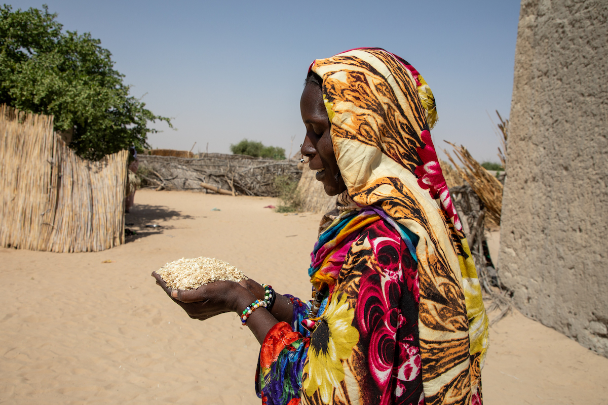 Sala Gana Ali showcases some of the millet bran she feeds her goats at her home in Ndjati village, Baga Sola. (Photo: Eugene Ikua/Concern Worldwide)