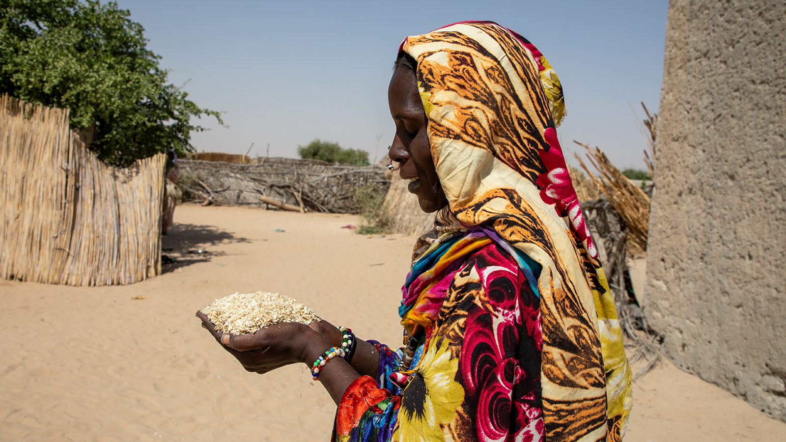 Gana Ali (40) showcases some of the millet bran she feeds her goats at her home in Ndjati village, Baga Sola. (Photo: Eugene Ikua/Concern Worldwide)