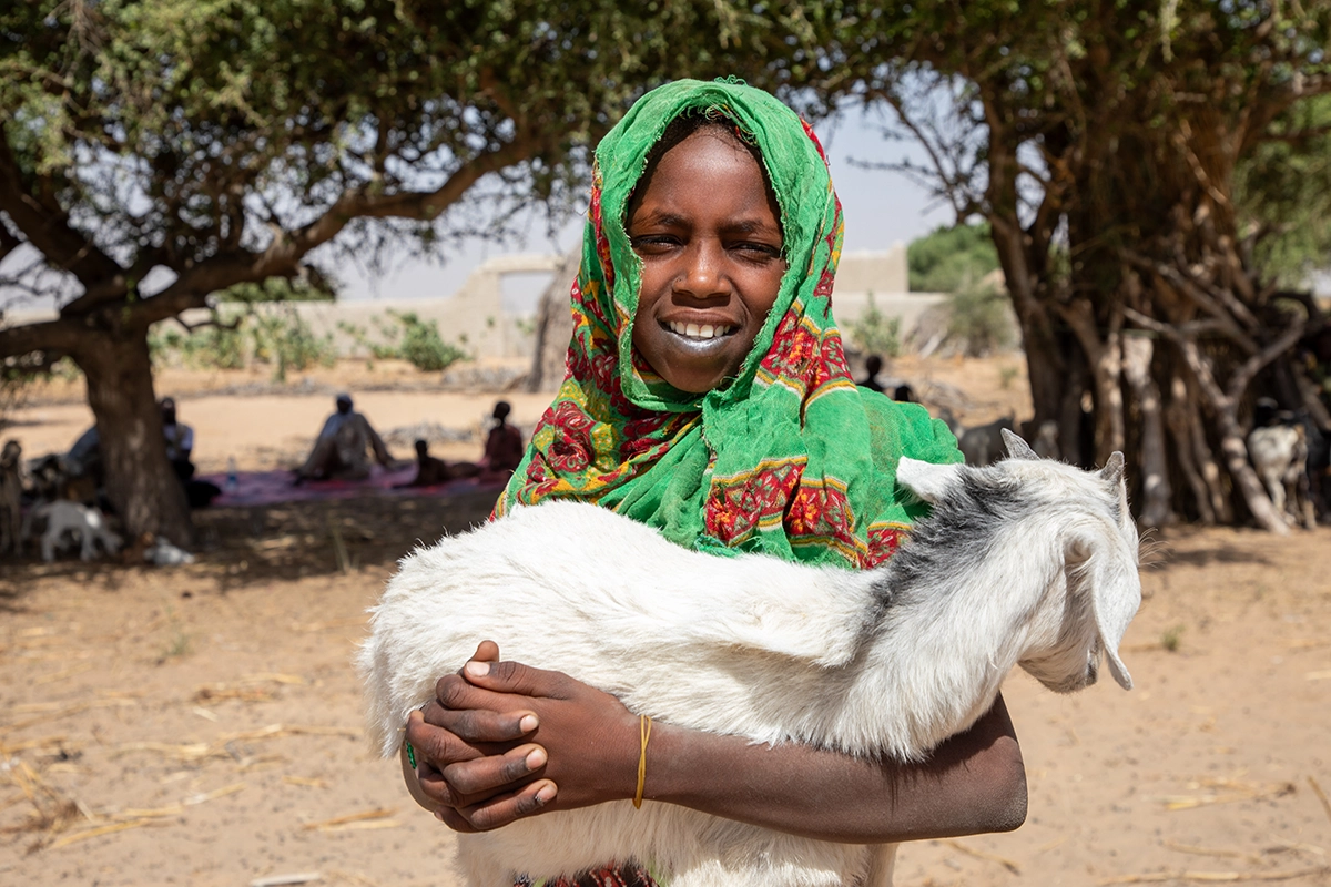 Salmata's daughter, Aichta (9), holds up one of the family's goats in Ndjati Village. (Photo: Eugene Ikua/Concern Worldwide)